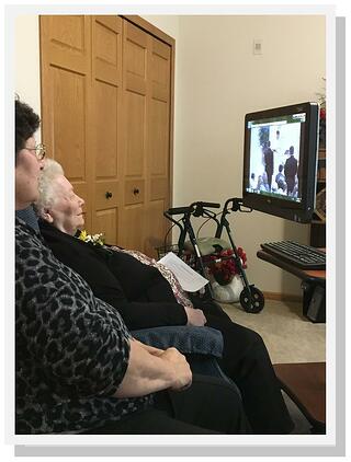 Valeria watches the wedding streaming live on the Internet in the company of family friend Lavonne Bratsch at Kingsway Retirement Living. 