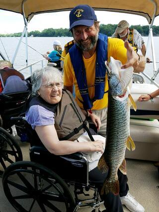 Pictured is Hope resident Ramona K., 85., with a Let’s Go Fishing guide on Cedar Lake.